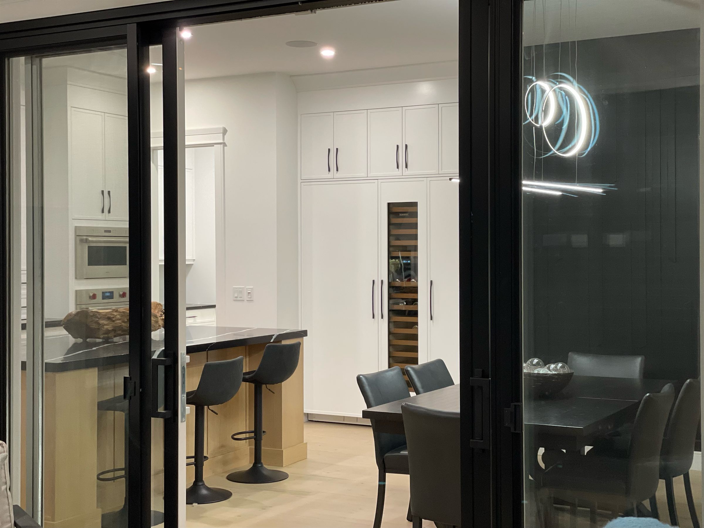 Looking through open deck doors into the kitchen