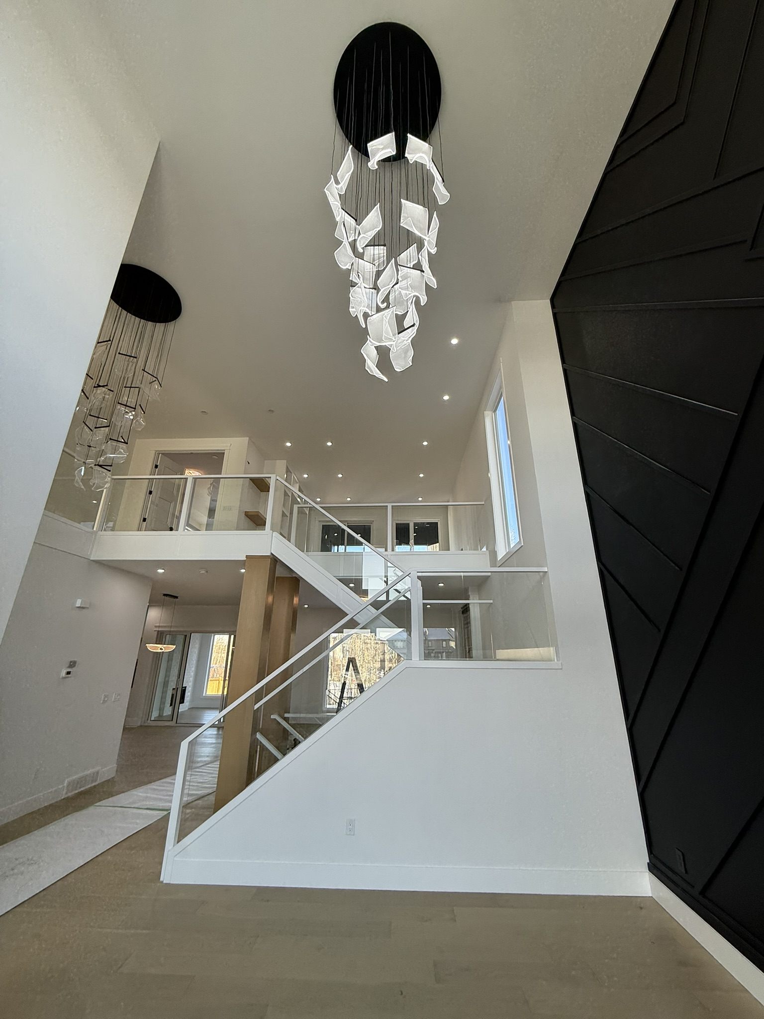 Sculptural pendants over a two-storey stairwell