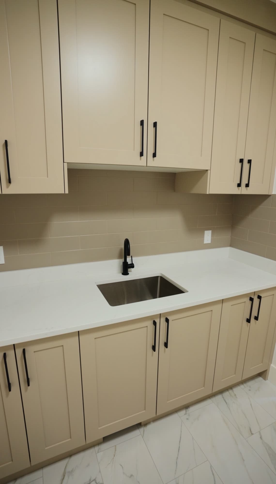 Taupe cabinetry with an undermount sink and a quartz counter
